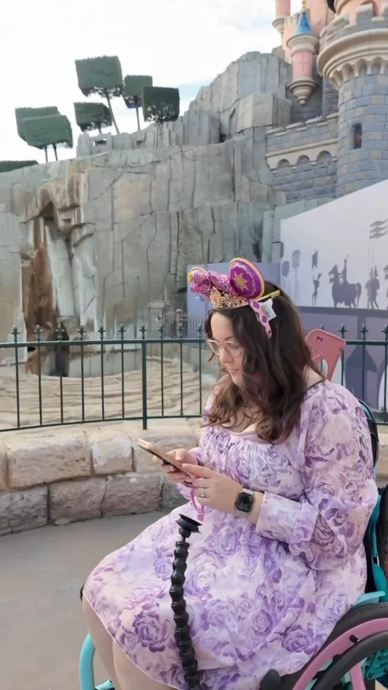 AD | The best disability-related item I took to Disneyland Paris! ♿️✨
Honestly, where has this been all my life?!

This Flexi Phone Holder from @theactivehandsco is a must-have! As someone with tremors and involuntary movements, my phone has a habit of suddenly ending up on the floor, especially when it’s balanced on my lap while I’m wheeling around. This has completely changed that.

It uses a really clever Fidlock vacuum system, with magnets helping your phone snap into place and a vacuum seal holding it securely. So I can just pop my phone onto the grip and wheel around without constantly worrying about sending it flying. 

The thing I loved MOST was being able to have the Disneyland Paris map and navigation right in front of me while I wheeled. No having to keep stopping, getting my phone out, checking where I was going and putting it away again. It was just there whenever I needed it!

Now I'm back, I use it all the time day-to-day too and I wouldn't want to be without it. 

If you want to try one, you can get 10% off with my code MaliFPH10 at:
 www.activehands.com/product/flexi-phone-holder/

They also have another version that clips on both sides and is designed to be compatible with a DSLR camera, which looks SO cool and is now firmly on my list.

AD: PR gifted product, but all thoughts are my own. I genuinely love this!