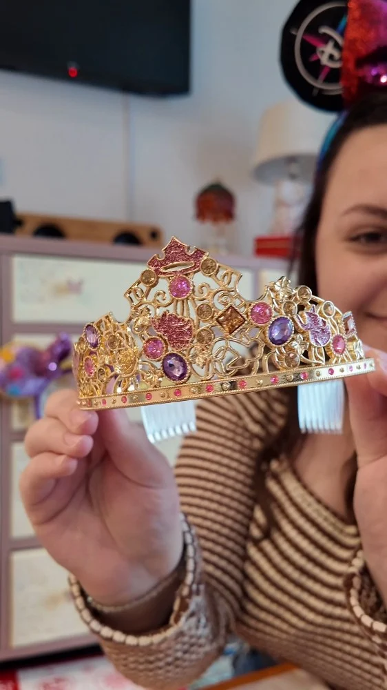 Time for a Disneyland merch haul... which piece was your favourite? 
I love the array of shops at Disneyland Paris - you really can find the most unique things. 

VD: Imali, a white woman with brown hair wearing Mickeys shows you various things she brought back from Disneyland Paris for herself and as gifts.